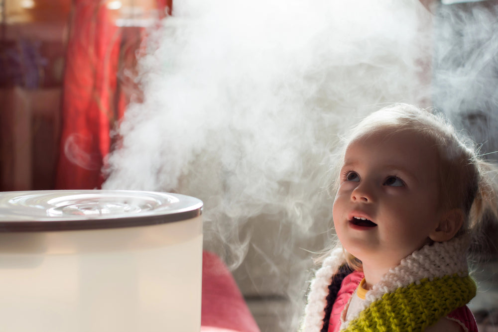 Baby next to a humidifier