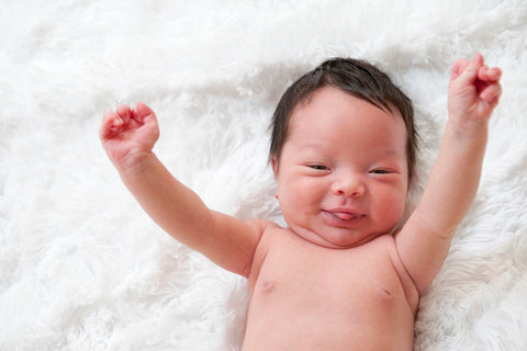 Newborn grinning after sneezing