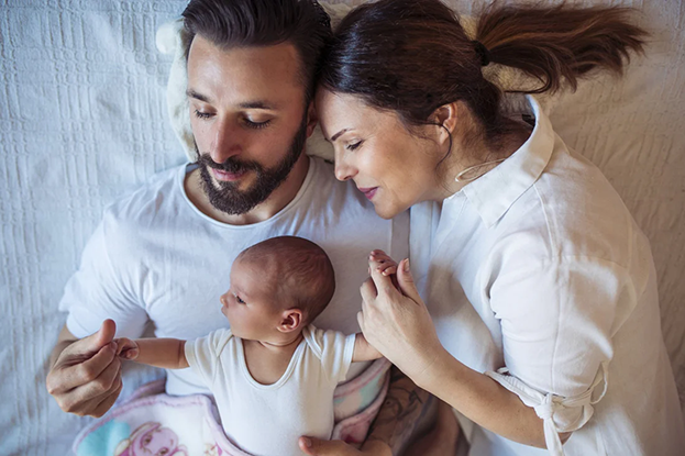 Parents snuggling with newborn