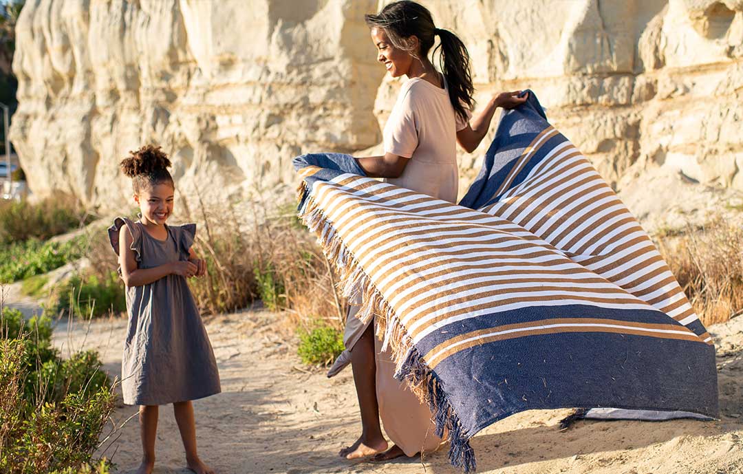 how to wash your cotton blanket women on beach with young child 