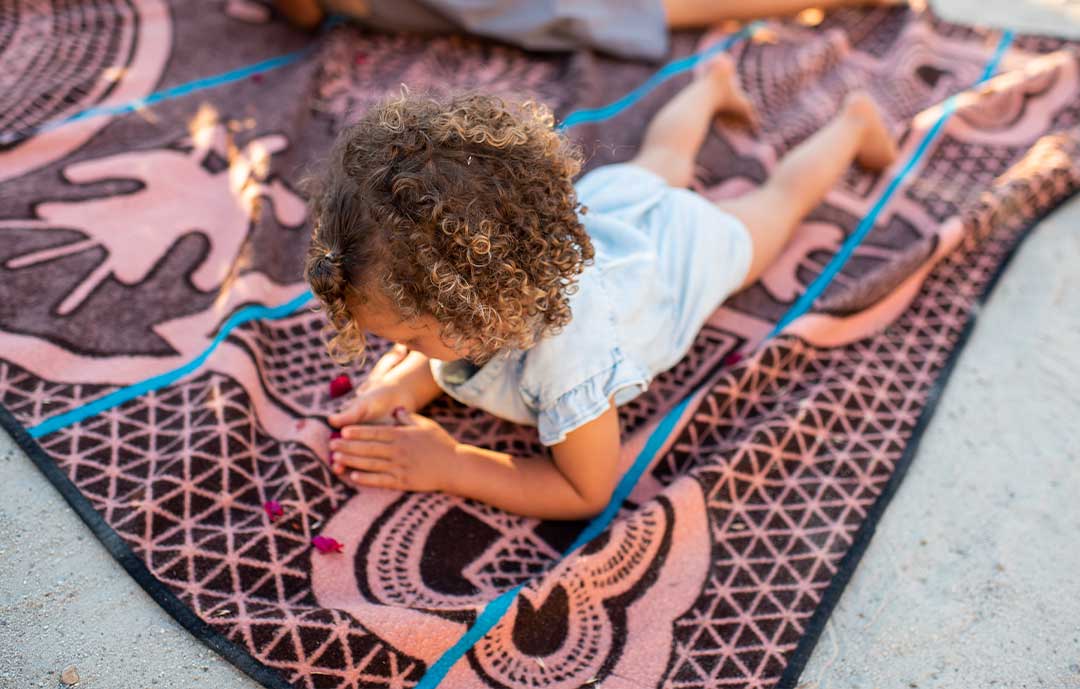 Basotho Heritage African Blanket with young child on a beach