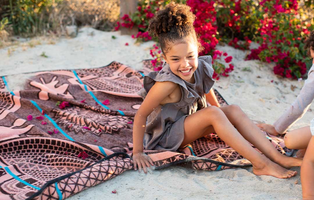Young girl sitting on a Basotho blanket