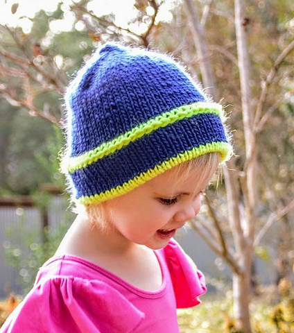 Girl wearing blue and yellow beanie.