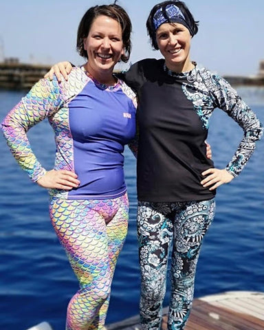Two women wearing Spacefish army mermaid leggings.