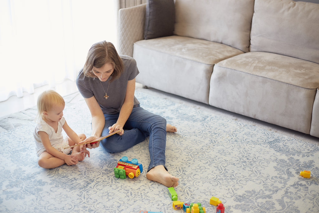 Mom and baby on floor play mat