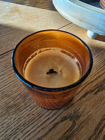 Previously lit candle with wood wick that needs to be trimmed.