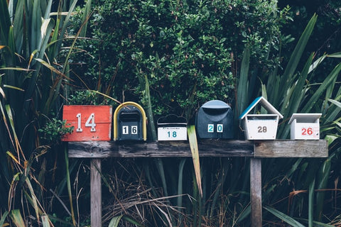 A row of coloful USPS mailboxes