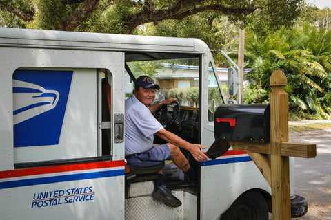 USPS carrier delivering mail