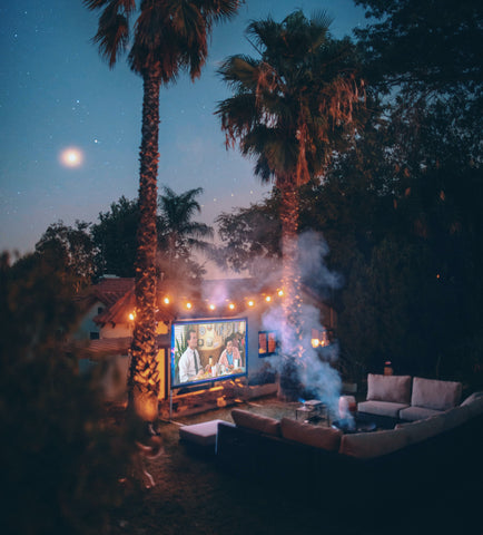 backyard movie night set up with big screen