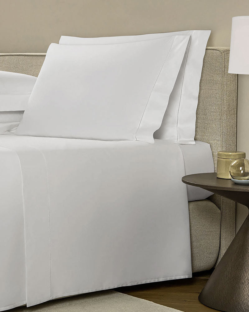 White Cotton Sateen Sheet Set, with a flat sheet, a fitted sheet, and four pillowcases from St. Pierre.
