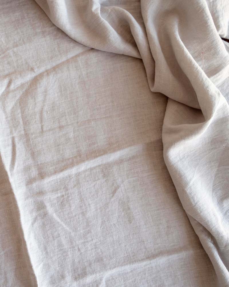 top view of a significantly wrinkled beige linen sheet