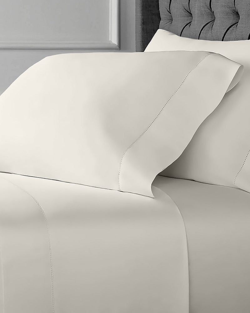 Beige Cotton Sateen Sheet Set, with a flat sheet, a fitted sheet, and two pillowcases from St. Pierre.