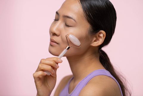 Woman massaging her face with a roller