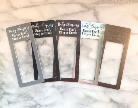 5 baby sleeping laminate doorbell surrounds on a marble background