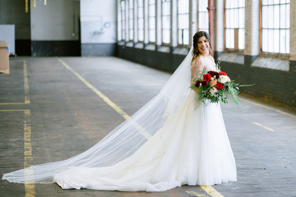 The Stella wedding dress has a sweetheart neckline with illusion straps, natural waist A-line skirt. Crystal starburst like beading throughout bodice, cascading onto skirt. Perfect for the celestial or ethereal bride. #celestialweddingdress #etherealweddingdress #etherealbride #weddingdress #weddingdressstyles