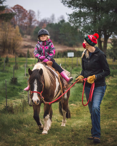 Duncan and Valerie going on a pony ride