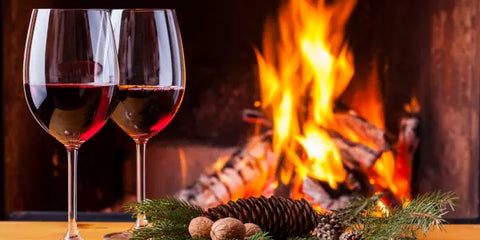 Glass of red wine by the fireplace