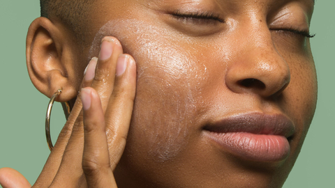 black woman cleansing skin