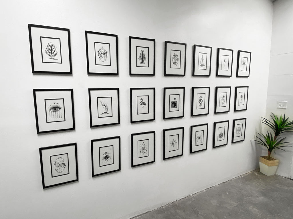 Wall of illustrations by Karien Bredenkamp for "Seen" exhibition