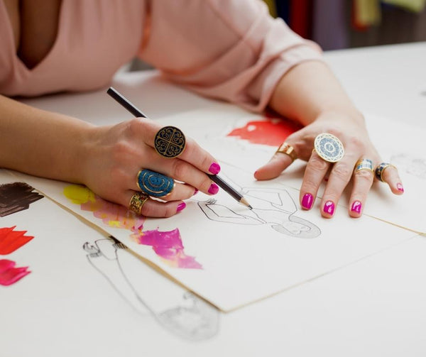 manos de mujer creando un boceto de diseño de moda