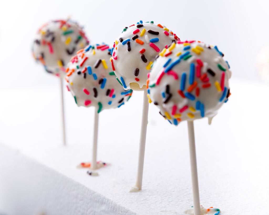 Placing the decorated cake pops in styrofoam to set