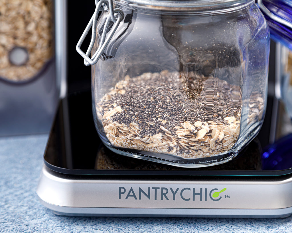 Chia seeds being added to the rolled oats in the jar