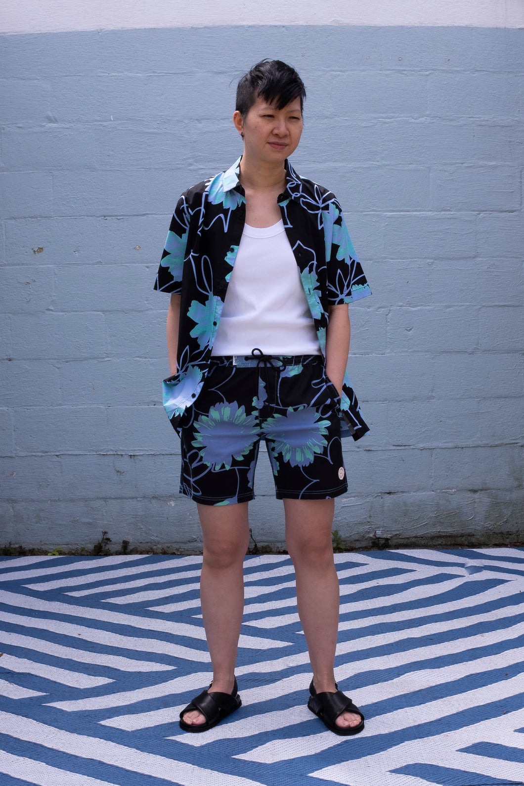 Globe Dreamin' Wild Shirt and Poolshort in Black, styled with Homecore's Connor tank top in white, plus Amy Sandals from Sister x Soeur for a breezy summer! - front