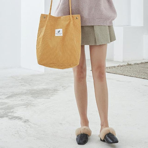 woman with yellow tote bag
