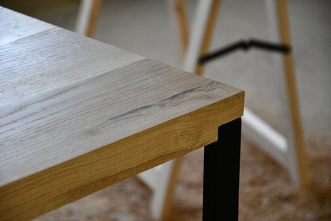 Black metal legs embedded in custom-made table