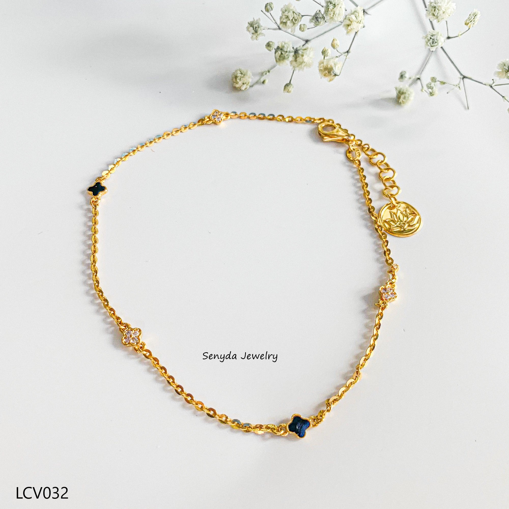 The Senyda's black petal anklet with stone-studded 4-petal flowers and lotus tail