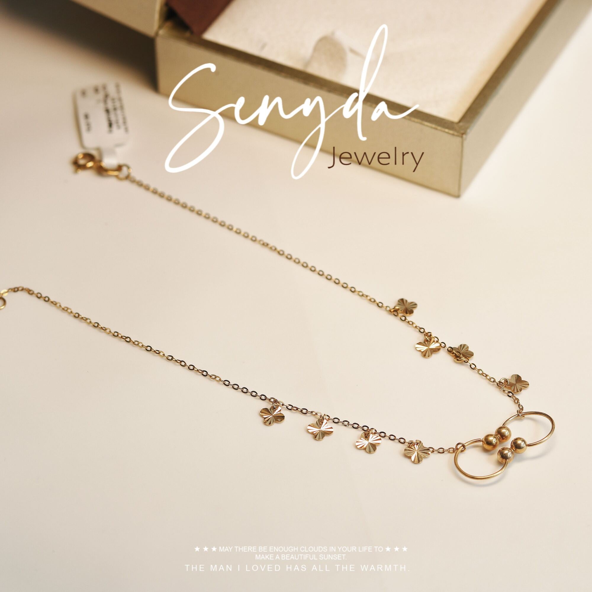 Senyda's gold anklet with 2 open circles and a 4-petal flower