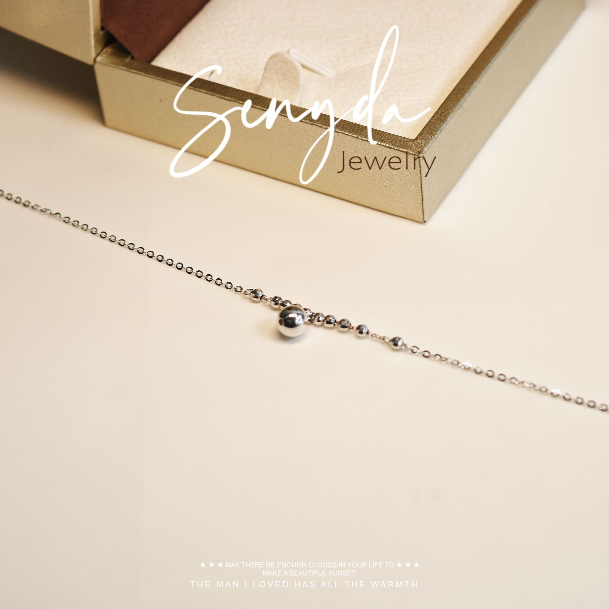 An anklet with a smooth bead design hangs from it