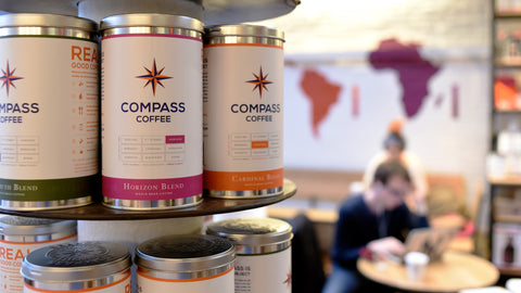 Three compass coffee tins
