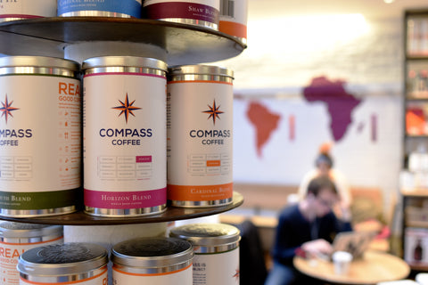 Three tins on a shelf in a cafe