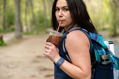 Girl drinking cold brew while hiking