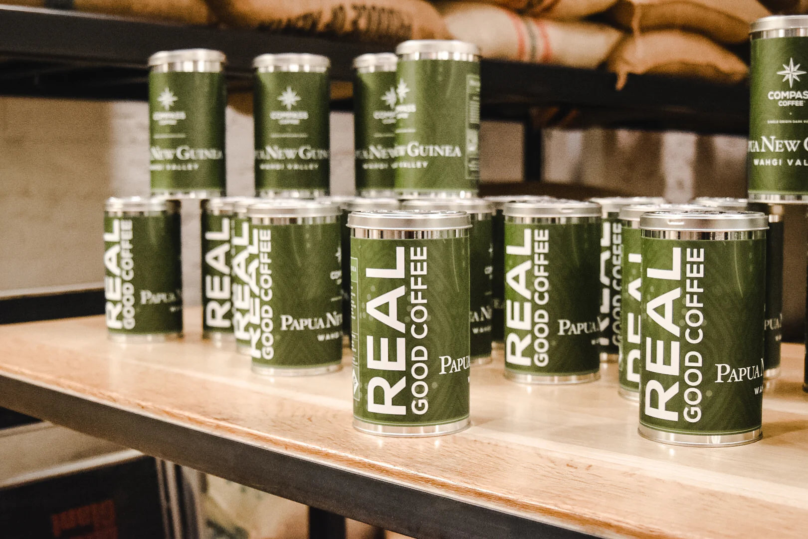 Papua New Guinea Compass Coffee tins on a table.