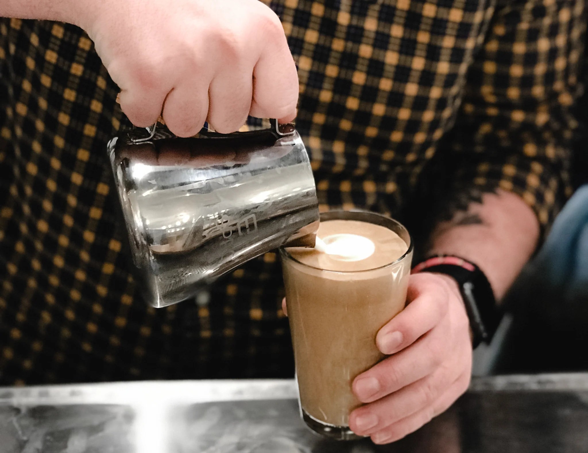 Making latte art on a glass, with Compass Coffee.