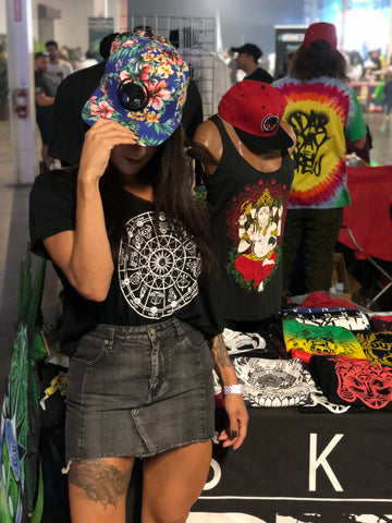 SmokeShowSoul at skinnybuddha booth modeling the clothing and SnapBack hats. Dab day miami