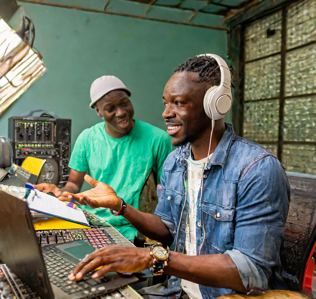 male-music-producer-talking-to-2-other-producers-asking-for-feedback-on-his-music.