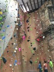 A woman climbs a section of climbing wall in a rock climbing gym not far from Miami, FL