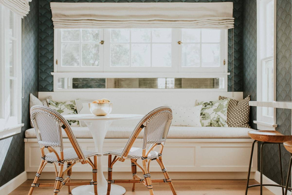 A home sitting room decorated with richly textured, dark green wallpaper