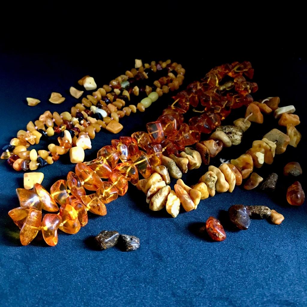 Amber strand jewellery showing the various colours Amber from light lemon yellow to honey-yellow to brown and even almost black