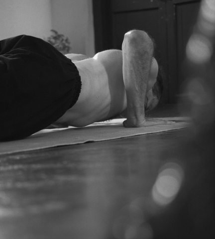 man practicing chaturanga dandasana on cotton yoga mat