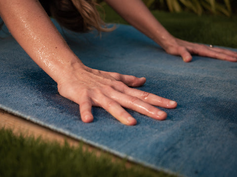 hands of girl practicing yoga hold perfect grip while sweating on yoga rug while staying in position downward facing dog