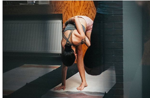 Primary series Ashtanga yoga on yoga rug 