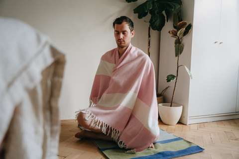 man meditating on cotton yoga rug 