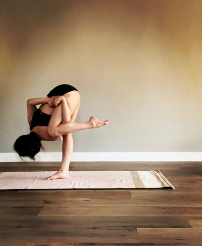 girl practicing flow yoga on pink yoga rug 