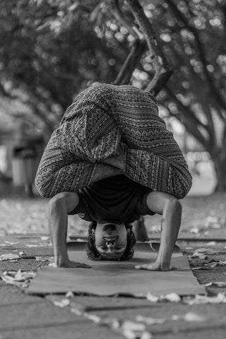 Man practicing yoga in the park