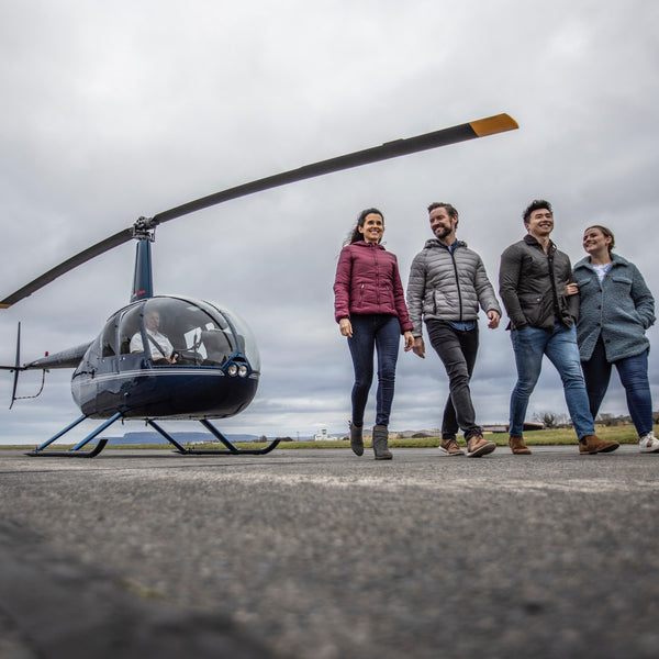 People walking in front of helicopt