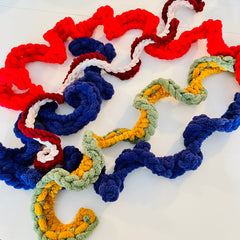 Multiple knitted chenille garlands against a white background
